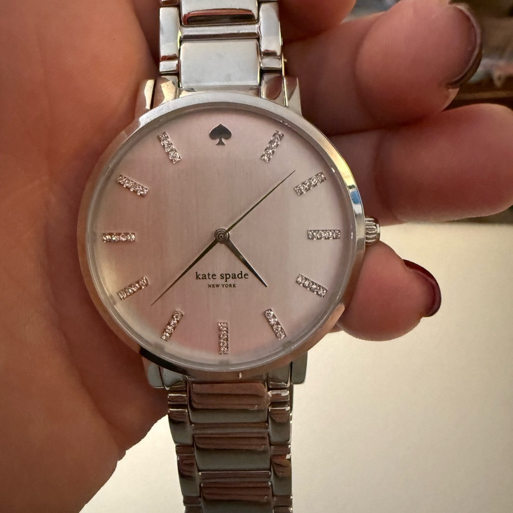 Kate Spade silver toned watch with rhinestone markers.